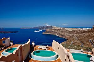 a resort with two jacuzzi pools and the ocean at Suites of the Gods Cave Spa Hotel in Megalokhori
