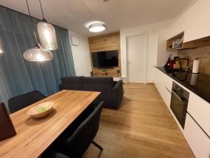 a living room with a dining room table and a couch at Planai Apartment Eishöhle in Schladming