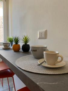 a table with two coffee cups on top of it at Alloggio Urbano - Centro Storico in Terni