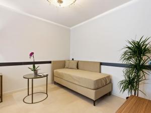 a bedroom with a bed and a table and two plants at Brand new boutique apartment in the heart of Venice in Venice