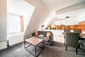 a living room with a couch and a table at Familienapartment Am Neumarkt ll in Dresden