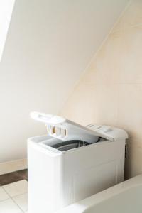 a white washer and dryer sitting under a stairs at Familienapartment Am Neumarkt ll in Dresden