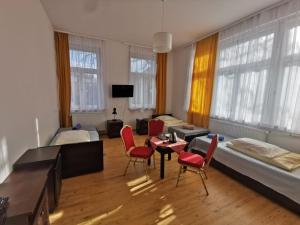 a room with two beds and a table and chairs at HOLTUR Kołobrzeg - Sanatorium Uzdrowiskowe in Kołobrzeg