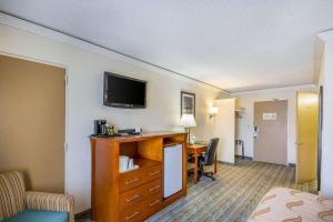 a hotel room with a desk and a television at Quality Inn & Suites Kansas City - Independence I-70 East in Independence