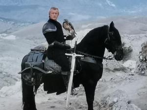 a man sitting on a horse in the snow at Casa MAMMUCCIA in Calascio