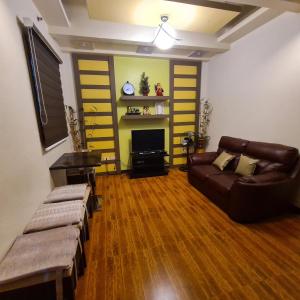 a living room with a couch and a tv at 722 Metropolis Tower Unit 212 in Bacolod