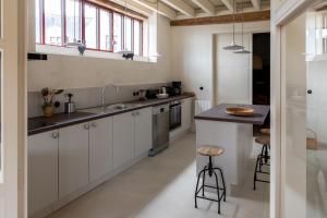 a kitchen with white cabinets and a sink and a counter at Gite de Vonnes in Pont-de-Ruan