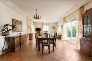 a kitchen and dining room with a table and chairs at Athenian Luxury Villa in Glyfada in Athens