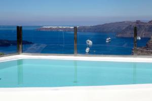 a swimming pool with a view of the water at Suites of the Gods Cave Spa Hotel in Megalokhori