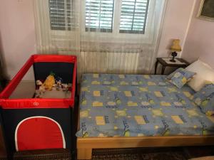 a small bedroom with a bed with a red frame at Zeleno i plavo in Kraljevica