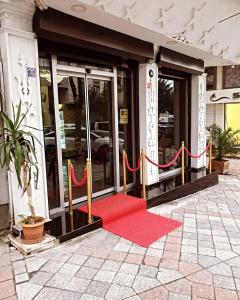 a red carpet entrance to a building with a red carpet at Stad Pansiyon AİLE in Istanbul