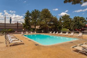 a pool with chaise lounge chairs and a bunch ofitures at Gold Country Inn and Casino by Red Lion Hotels in Elko