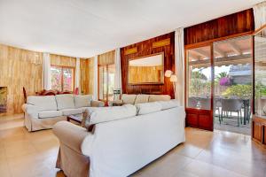 a living room with two couches and a table at Villa Maravillas by Slow Villas in Playa de Palma