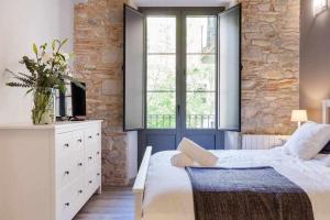 a bedroom with a white bed and a window at Sleep y Stay Home with balcony Bonaventura 3 in Girona