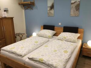 ein Schlafzimmer mit 2 Betten mit Kissen darauf in der Unterkunft Ferienwohnungen Heideidylle in Amelinghausen
