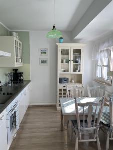 a kitchen with a table and chairs in a room at Haus in der Gartenstadt in Bottrop