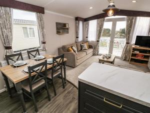 a kitchen and living room with a table and chairs at Castleview 22 in Carmarthen