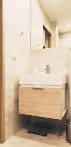 a bathroom with a sink and a mirror at Studio City centre Lutomierska Manufaktura in Łódź