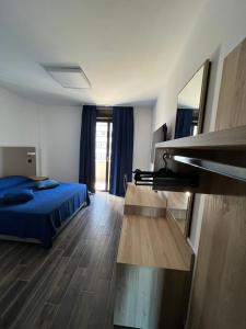a bedroom with a bed and a desk at Tiby Hotel in Modena