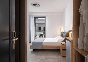 a bedroom with a bed and a large window at Casa Anastasia premium stay in Toroni