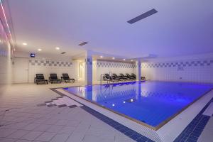 a large swimming pool in a large room at Residenz Seestern Wohnung 49 in Boltenhagen