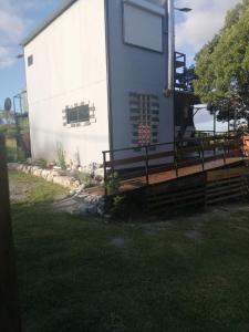 a home with a porch and a building at LeBruBi in Villa Serrana