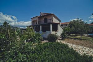 a house with a balcony on top of it at Villa Gem in Mravince