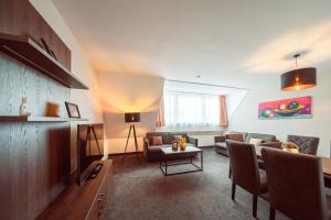 a living room with a couch and a table at Familienapartment Am Neumarkt l in Dresden