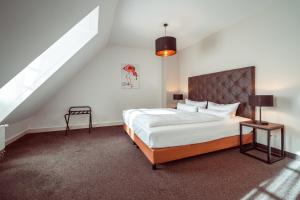 a bedroom with a large bed and a staircase at Familienapartment Am Neumarkt l in Dresden
