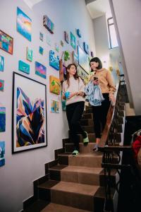 two people walking up the stairs in a house at People Hostel in Bishkek