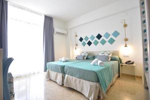 Postel nebo postele na pokoji v ubytování Hotel Gala Placidia