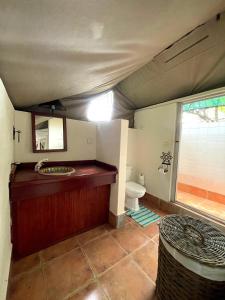 a bathroom with a sink and a toilet in a room at Maramba River Lodge in Livingstone