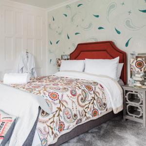 a bedroom with a bed with a colorful bedspread at The Naight House in Gloucester