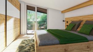 ザールバッハ・ヒンターグレムにあるBERGZEIT Appartementsのベッドルーム1室(大型ベッド1台、緑のシーツ付)