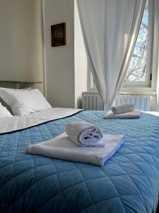 two towels on a bed in a bedroom at Villa Tergeste in Trieste