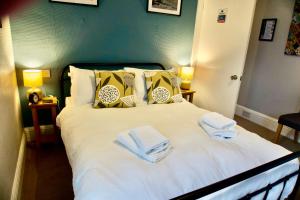 a bedroom with a bed with towels on it at Greystoke House in Keswick