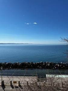 a view of the ocean with a rock wall at Villa Tergeste in Trieste