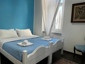 a bedroom with a bed with two towels on it at Villa Tergeste in Trieste