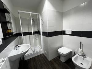 a bathroom with a sink and a toilet and a shower at Villa Tergeste in Trieste