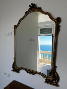 a mirror with a view of the ocean in a room at Villa Tergeste in Trieste