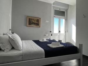 a bedroom with a bed with two towels on it at Villa Tergeste in Trieste