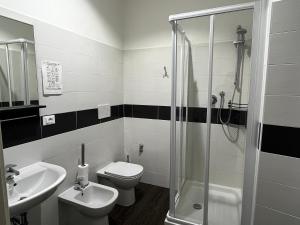 a bathroom with a toilet and a sink and a shower at Villa Tergeste in Trieste