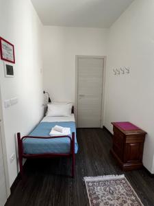 a small bedroom with a bed and a table at Villa Tergeste in Trieste