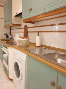 a kitchen with a washing machine and a sink at Amalthea Guest House in Kos +35 photos