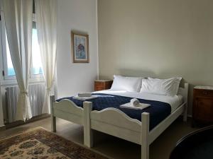 a bedroom with a bed with towels on it at Villa Tergeste in Trieste
