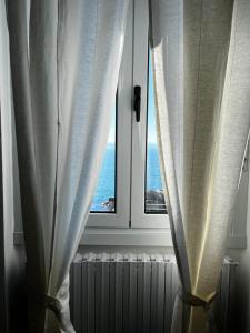 a window with a view of the ocean at Villa Tergeste in Trieste