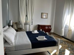a bedroom with a bed with two towels on it at Villa Tergeste in Trieste