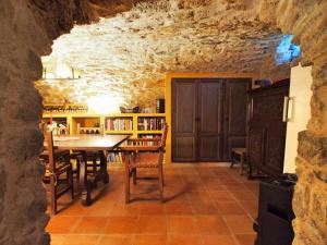 a dining room with a table and chairs in a cave at Masia with pool and beautiful views near Girona in Girona