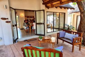 a living room with a person sitting at a table at Switsongo Boutique B&B in Hoedspruit