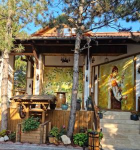 a painting of a woman on the side of a house at Hotel Casa Romaneasca in Otopeni